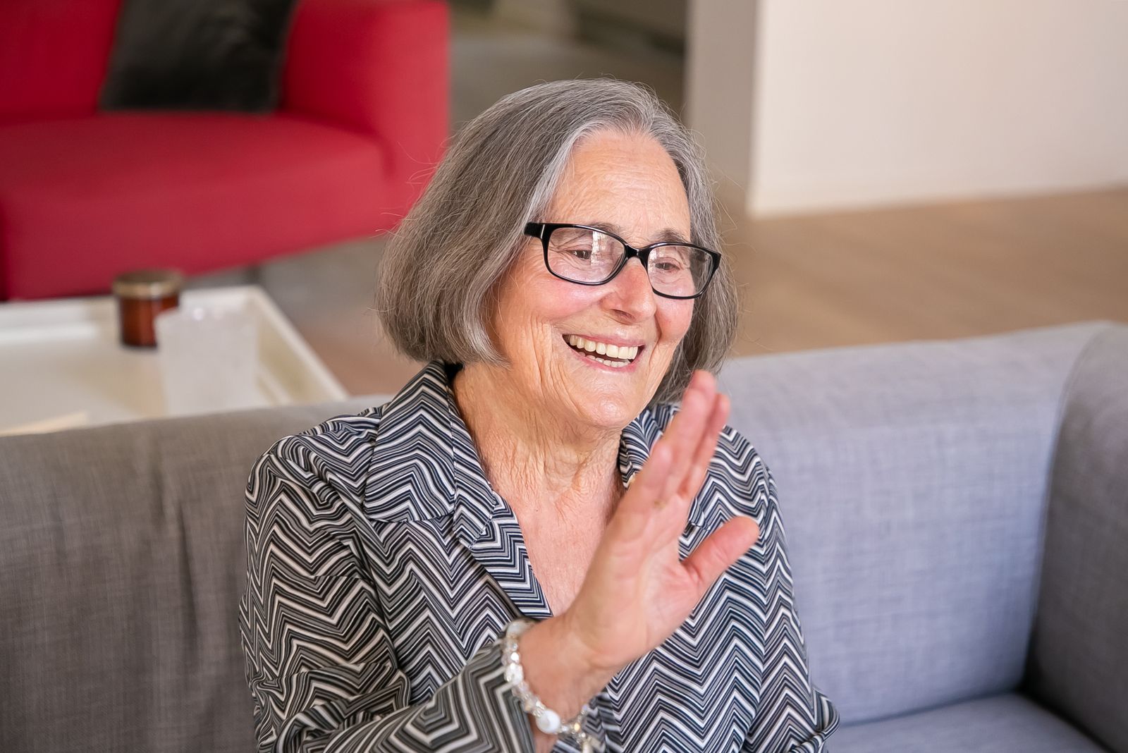 A happy senior smiling at home, supported by TrueHeart care